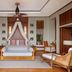 Anantara Maia Seychelles Villas in Anse Boileau: airy villa bedroom with canopy daybed and wicker chairs