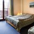Hotel Hajnal in Mezőkövesd guest room with two beds and balcony door