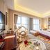 Grand Metropark Guofeng Hotel Tangshan guest room with king bed, children’s play area and large window in Tangshan
