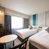 Hotel Jal City Nagasaki room in Nagasaki with two twin beds, TV, and large window