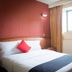 Hotel Santa Maria Mexico City guest room with double bed, red accent wall, and window with curtains