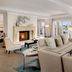 Balboa Bay Resort Newport Beach suite with fireplace, seating area and bay view through large windows