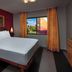 Disney's Art Of Animation Resort guest room with king bed, TV, and window view in Lake Buena Vista