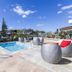 Rhapsody Resort in Surfers Paradise with outdoor pool, spa tub and lounge seating under a blue sky