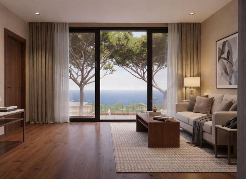Marepineta Resort in Cervia with living room, sliding doors, and sea view through trees.