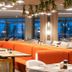 Kleopatra Dreams Beach Hotel in Alanya: modern lounge with orange banquette seating and hanging lights