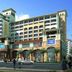 Clayton Hotel Guangzhou exterior with multi-story facade, arched entrance, and street view