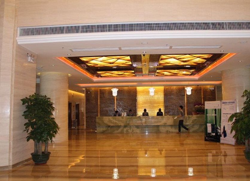 Clayton Hotel Guangzhou lobby with marble reception desk, polished floor and ornate ceiling lighting