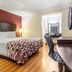 Red Roof Inn Phoenix-Midtown guest room with king bed, desk, and wood floors in Phoenix