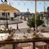 Abrivado in Saintes-Maries-de-la-Mer outdoor café terrace with tables and umbrellas