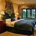 Holbeck Ghyll Country House Estate in Windermere bedroom with plaid curtains, twin lamps, and a bay window
