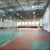 Changchun Huatian Hotel in Changchun features a large indoor tennis court under a high metal roof.