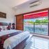 Kamar Kamar Boutique Hotel in Kuta: bright guest room with king bed and balcony view