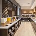Hyatt Place South Reno breakfast buffet with hot dishes and drink dispensers in a modern dining area