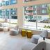 Aloft Seattle Redmond lobby with floor-to-ceiling windows and modern lounge seating in Redmond