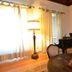 Casa Do Condado De Beiros in São Pedro do Sul: elegant lounge with grand piano, chessboard, and tall windows