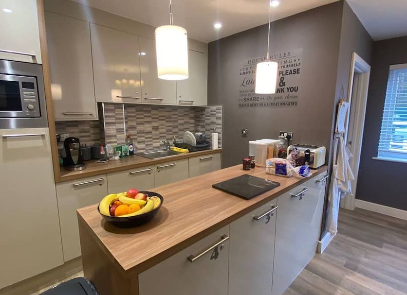 Deepcut Lodge Bed & Breakfast Self Service Camberley self-service kitchen with island, pendant lights and fruit bowl