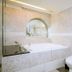 Guide Hotel Taipei Xinyi bathroom with bathtub, sink, toilet, and wall mirror in Taipei City