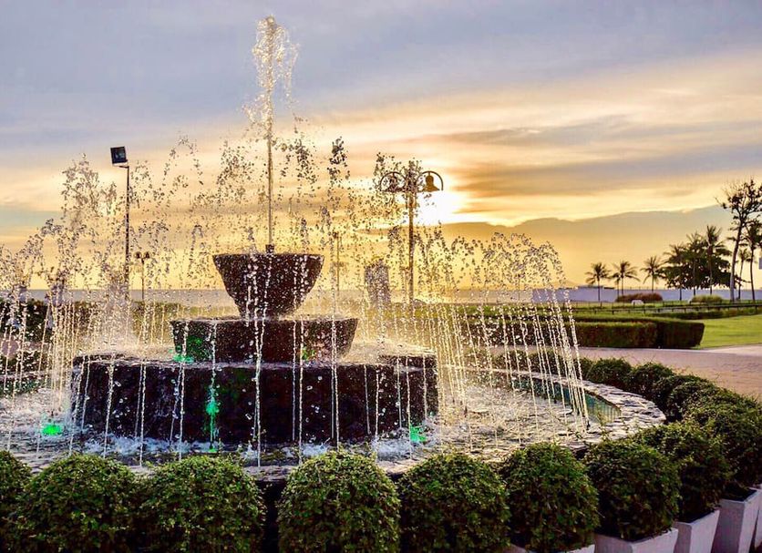 Ambassador City Jomtien Pattaya - Ocean Wing fountain in landscaped garden at sunset, Pattaya