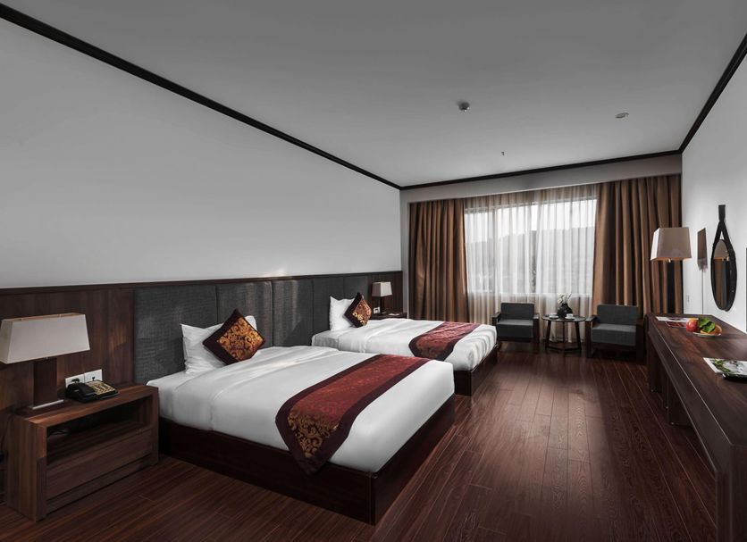 Lao Cai Star Hotel in Lao Cai: twin beds in a modern guest room with window seating