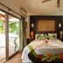 Le Relax Beach Resort in Grand'Anse Praslin: beachfront guest room with bed, balcony doors, and wood wardrobe