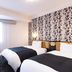 Apa Hotel Kanazawa Nishi twin room in Kanazawa with patterned accent wall and window seating