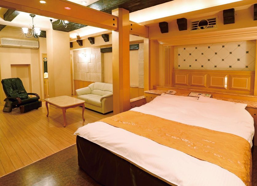 Hotel Fine Garden Juso Osaka guest room with bed, sofa, coffee table and massage chair