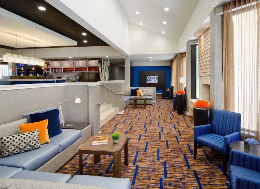 Courtyard by Marriott Kansas City Overland Park/Metcalf lobby lounge with seating and bright windows