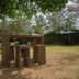 Balis Best Bar and Resort Nairobi outdoor garden seating area with table and chairs under trees