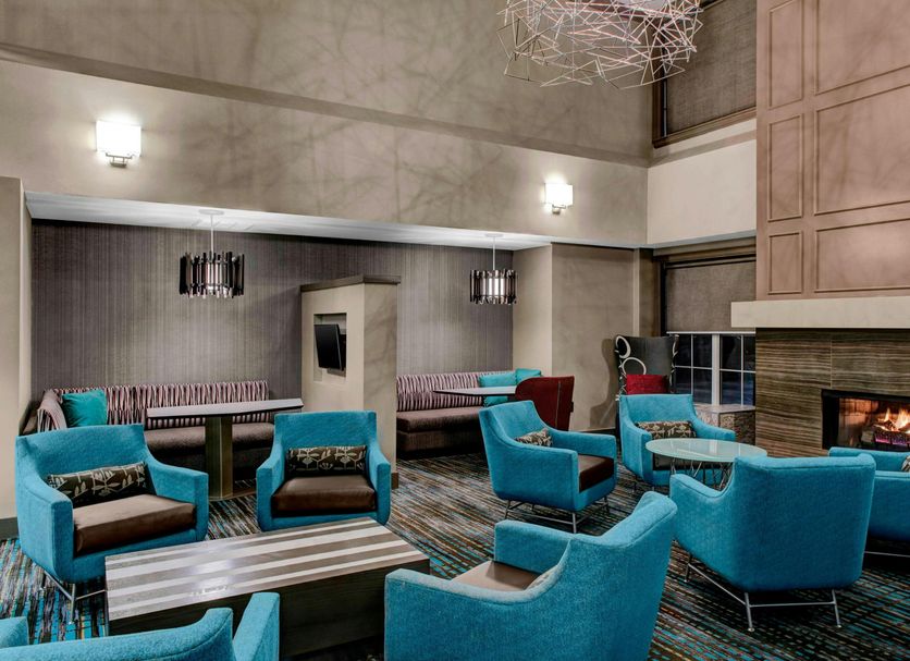 Residence Inn by Marriott Cleveland-Beachwood lounge with turquoise chairs and a fireplace in Beachwood