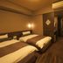 Dormy Inn Premium Hakata Canal City Mae Natural Hot Spring room in Fukuoka with two beds and desk
