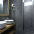 Oliva Hotel, Veszprém: modern bathroom with twin vessel sinks, large mirror, and walk-in shower