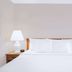Days Inn by Wyndham Wytheville guest room with neatly made bed and bedside lamps