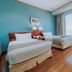 The Peninsula Chittagong Limited guest room with two twin beds and city view in Chittagong