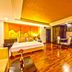 The Heritage Sathorn Suite Hotel in Bangkok: spacious suite with bed, kitchenette, and wood flooring