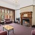 Riverfront Motel & Restaurant in Berriedale living room with fireplace, bay windows, and seating area