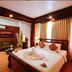 Angkor Pearl Hotel in Siem Reap guest room with king bed, sofa, and warm lighting