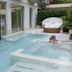 Hotel 4 Stagioni Sensus Spa in Bardolino with an outdoor pool and guests relaxing in the water