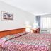 Vantage Point Inn - Woodland Hills guest room with two beds, TV, desk, window and wooden door
