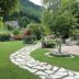 Hotel Calvi-Ristorante Mainor in Vittorio Veneto: landscaped garden with stone path and mountain backdrop