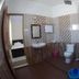 Sr Residency, Tiruchirappalli bathroom with toilet, sink, shower area and patterned tile walls