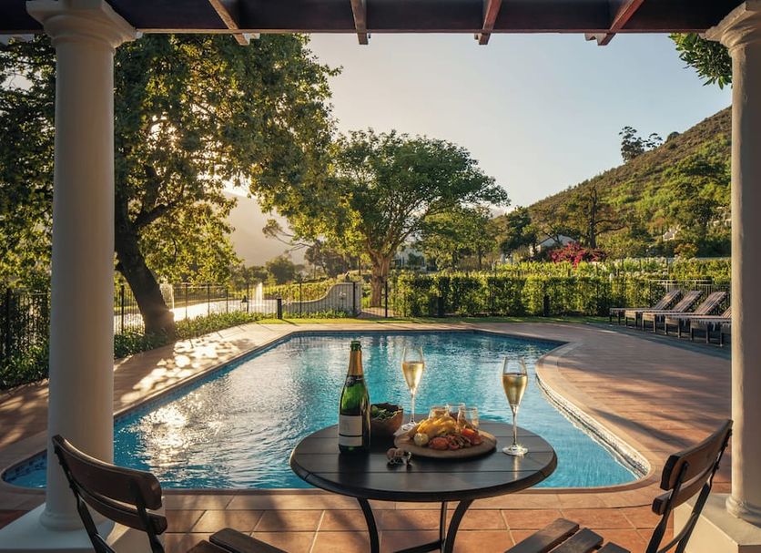 Leeu Estates, Franschhoek: private pool terrace with wine and a mountain view
