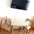 Gästehaus Klug in Sankt Stefan ob Stainz with wall-mounted TV and small table with two chairs