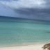 Fun Holiday Beach Resort in Negril with turquoise ocean waves and people swimming by the sandy beach