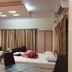 Hotel Sea Coast, Digha: twin beds in a guest room with curtains, wardrobe and ceiling lights