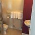 The Kings Arms London bathroom with shower, toilet, sink and towel rack