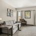 Residence Inn by Marriott Davenport suite with sofa, chair, windows, and work desk