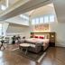 The Lalit London bedroom with skylights, sitting area and king bed in London