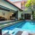 De' Bharata Bali Villas, Kuta: courtyard swimming pool beside tropical greenery and a covered patio