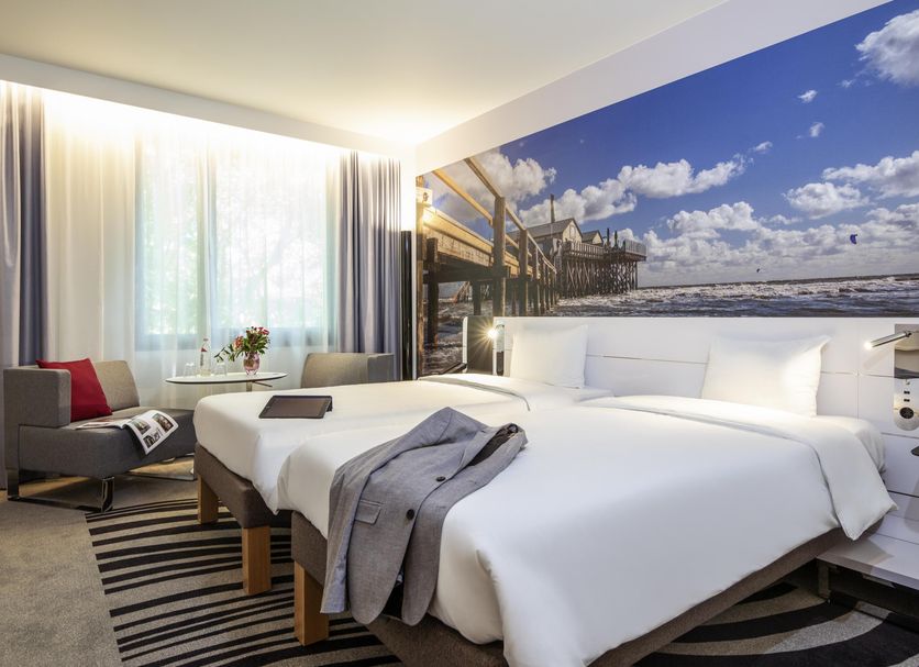 Novotel Hamburg City Alster room with twin beds, waterfront wall art, and large window in Hamburg